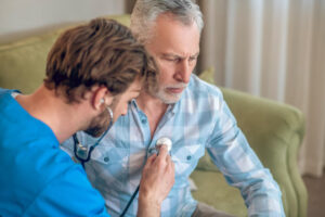 experienced-concentrated-physician-performing-cardiac-auscultation_259150-57394